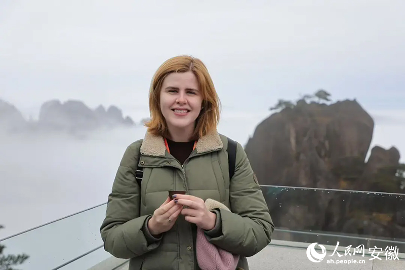 美國(guó)旅行商貝愛然與背后的云海合影。